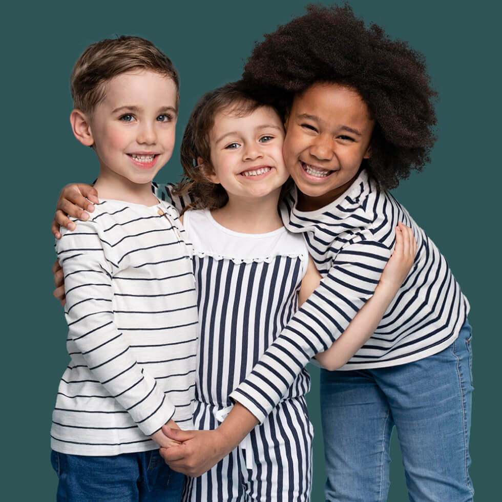 Mobile image of three kids smiling and holding hands